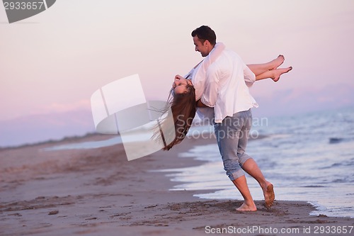 Image of young couple  on beach have fun