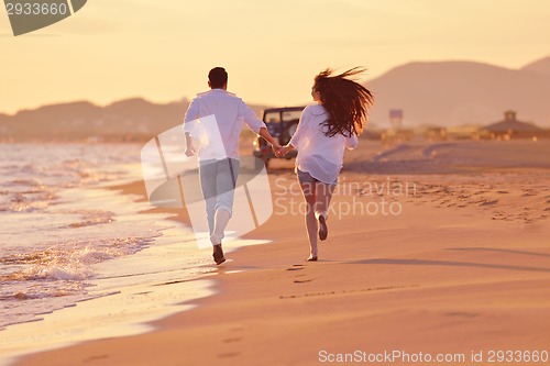 Image of young couple  on beach have fun