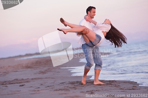 Image of young couple  on beach have fun