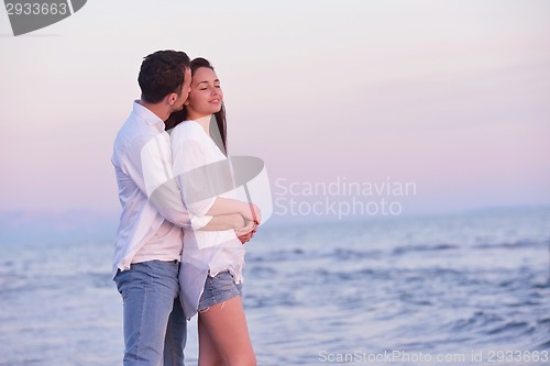 Image of young couple  on beach have fun