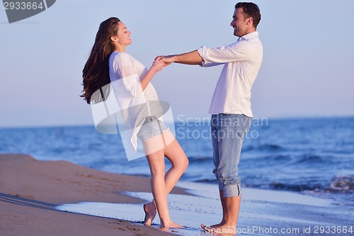 Image of young couple  on beach have fun