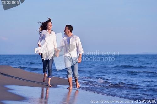 Image of young couple  on beach have fun