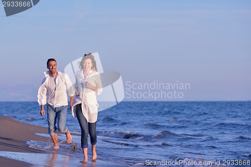 Image of young couple  on beach have fun