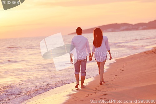 Image of young couple  on beach have fun
