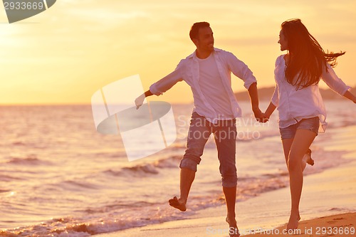 Image of young couple  on beach have fun