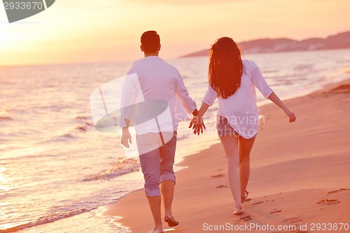 Image of young couple  on beach have fun