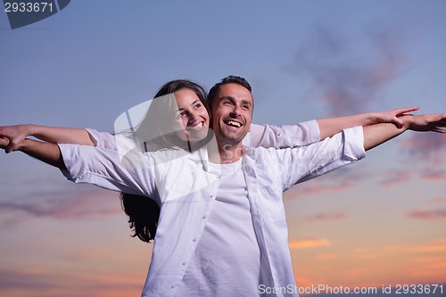 Image of young couple  on beach have fun
