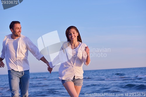 Image of young couple  on beach have fun