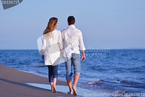 Image of young couple  on beach have fun