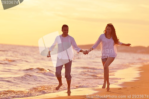 Image of young couple  on beach have fun
