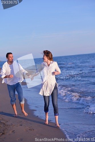 Image of young couple  on beach have fun