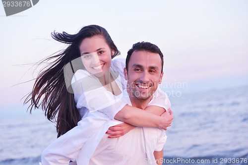 Image of young couple  on beach have fun