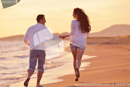 Image of young couple  on beach have fun