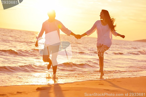 Image of young couple  on beach have fun