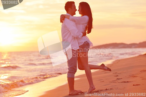 Image of young couple  on beach have fun