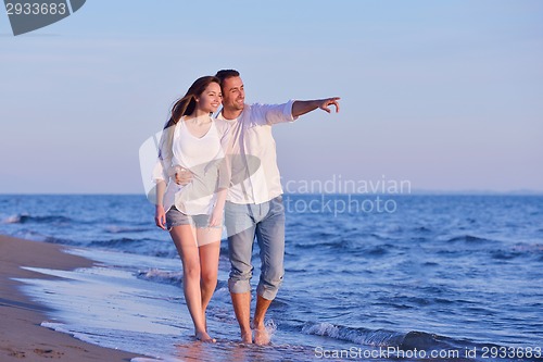 Image of young couple  on beach have fun