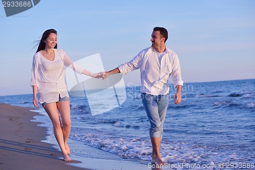 Image of young couple  on beach have fun