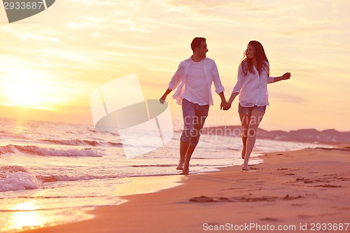 Image of young couple  on beach have fun