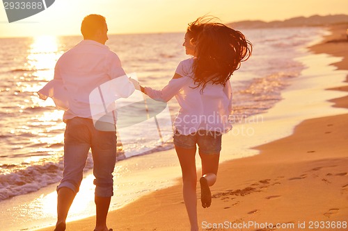 Image of young couple  on beach have fun