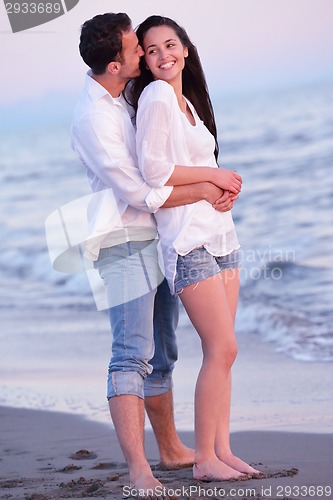 Image of young couple  on beach have fun