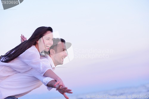 Image of young couple  on beach have fun