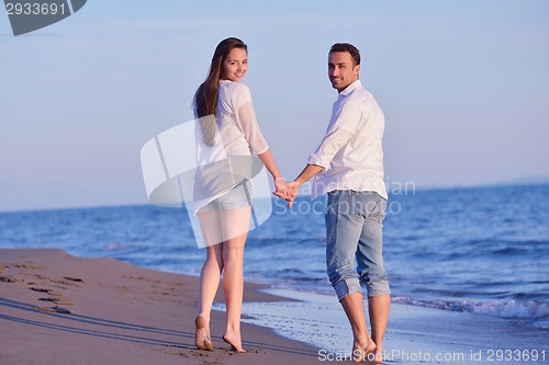 Image of young couple  on beach have fun