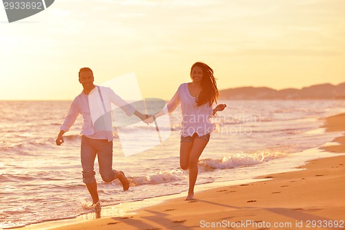 Image of young couple  on beach have fun