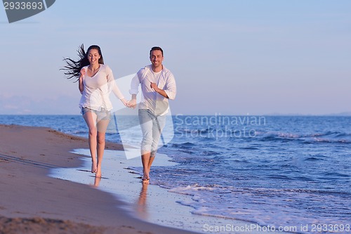 Image of young couple  on beach have fun