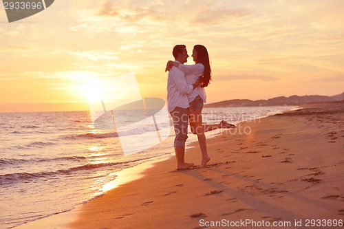 Image of young couple  on beach have fun