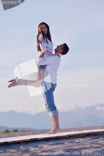 Image of young couple  on beach have fun