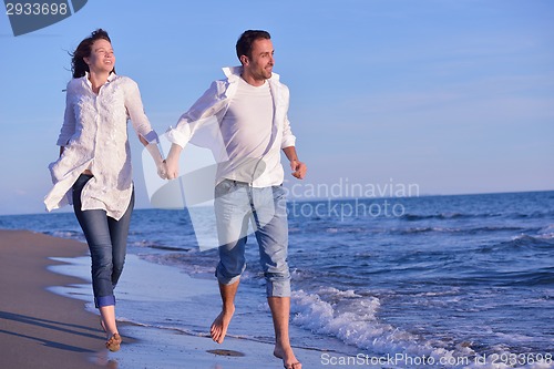 Image of young couple  on beach have fun