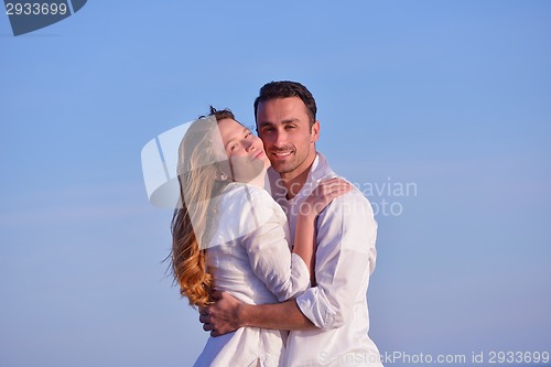 Image of young couple  on beach have fun