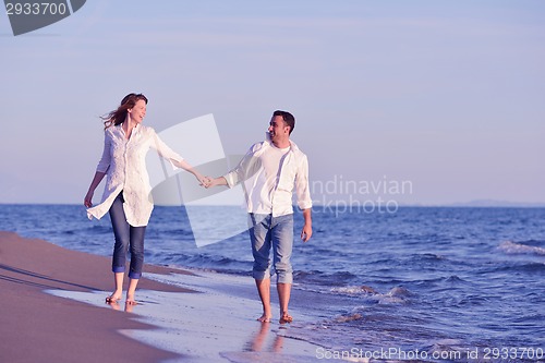 Image of young couple  on beach have fun