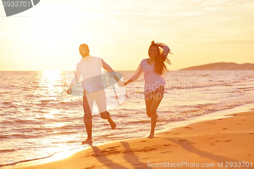 Image of young couple  on beach have fun