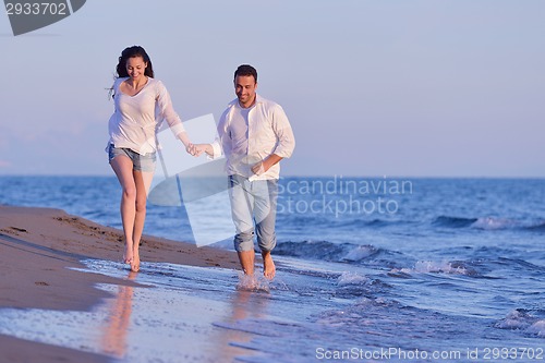 Image of young couple  on beach have fun