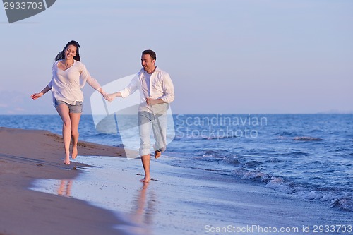 Image of young couple  on beach have fun