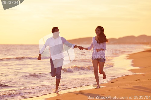 Image of young couple  on beach have fun
