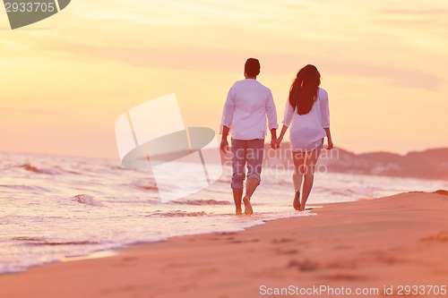 Image of young couple  on beach have fun