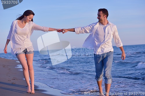 Image of young couple  on beach have fun