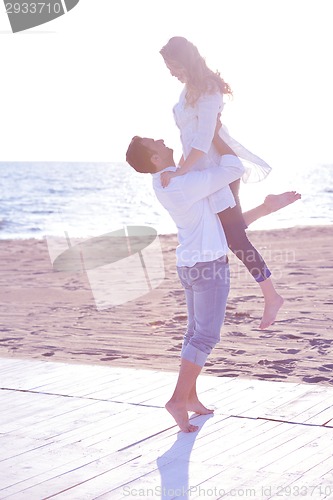 Image of young couple  on beach have fun