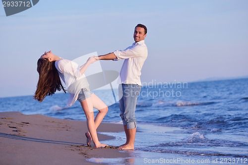 Image of young couple  on beach have fun