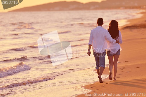 Image of young couple  on beach have fun