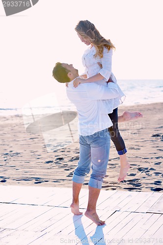 Image of young couple  on beach have fun