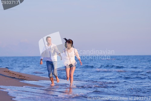 Image of young couple  on beach have fun