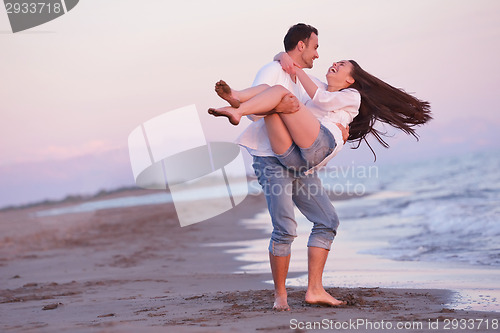 Image of young couple  on beach have fun