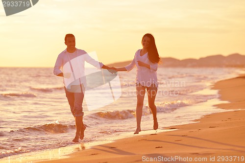 Image of young couple  on beach have fun