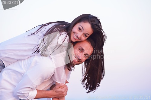 Image of young couple  on beach have fun