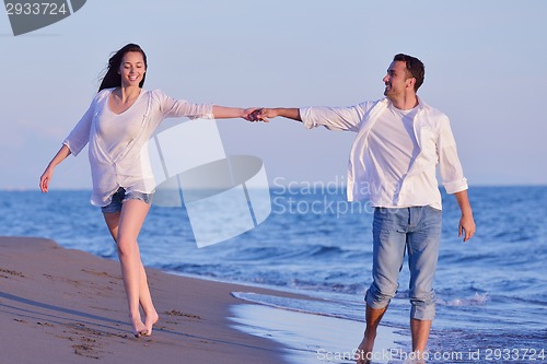 Image of young couple  on beach have fun