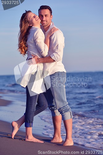 Image of young couple  on beach have fun
