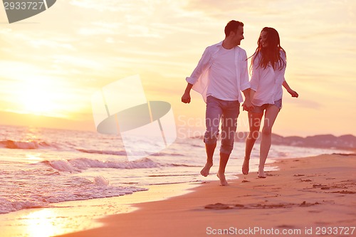 Image of young couple  on beach have fun